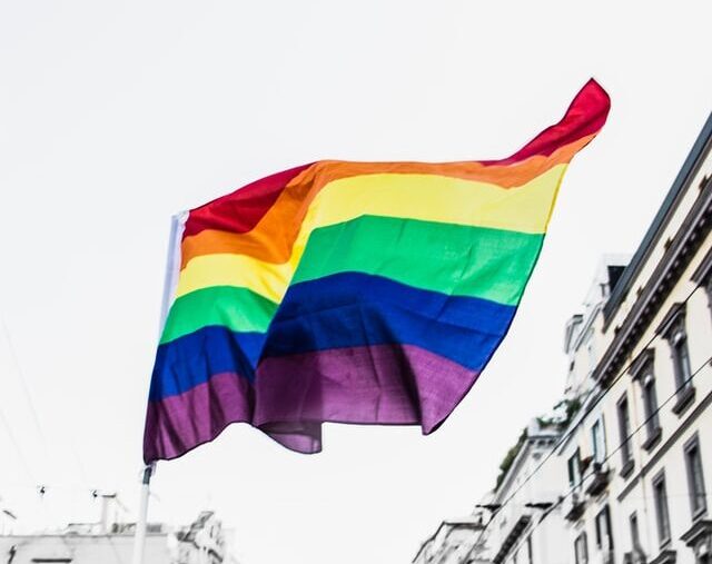 Flag with a display of Pride colours and the words "Love is Love"